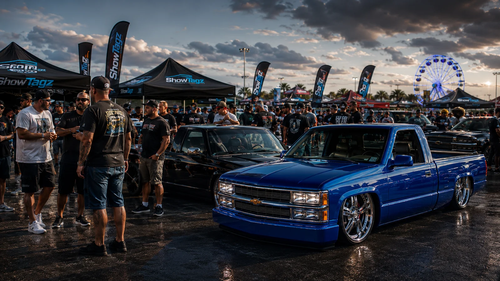 Crowd of vehicle enthusiasts standing around custom trucks at a show